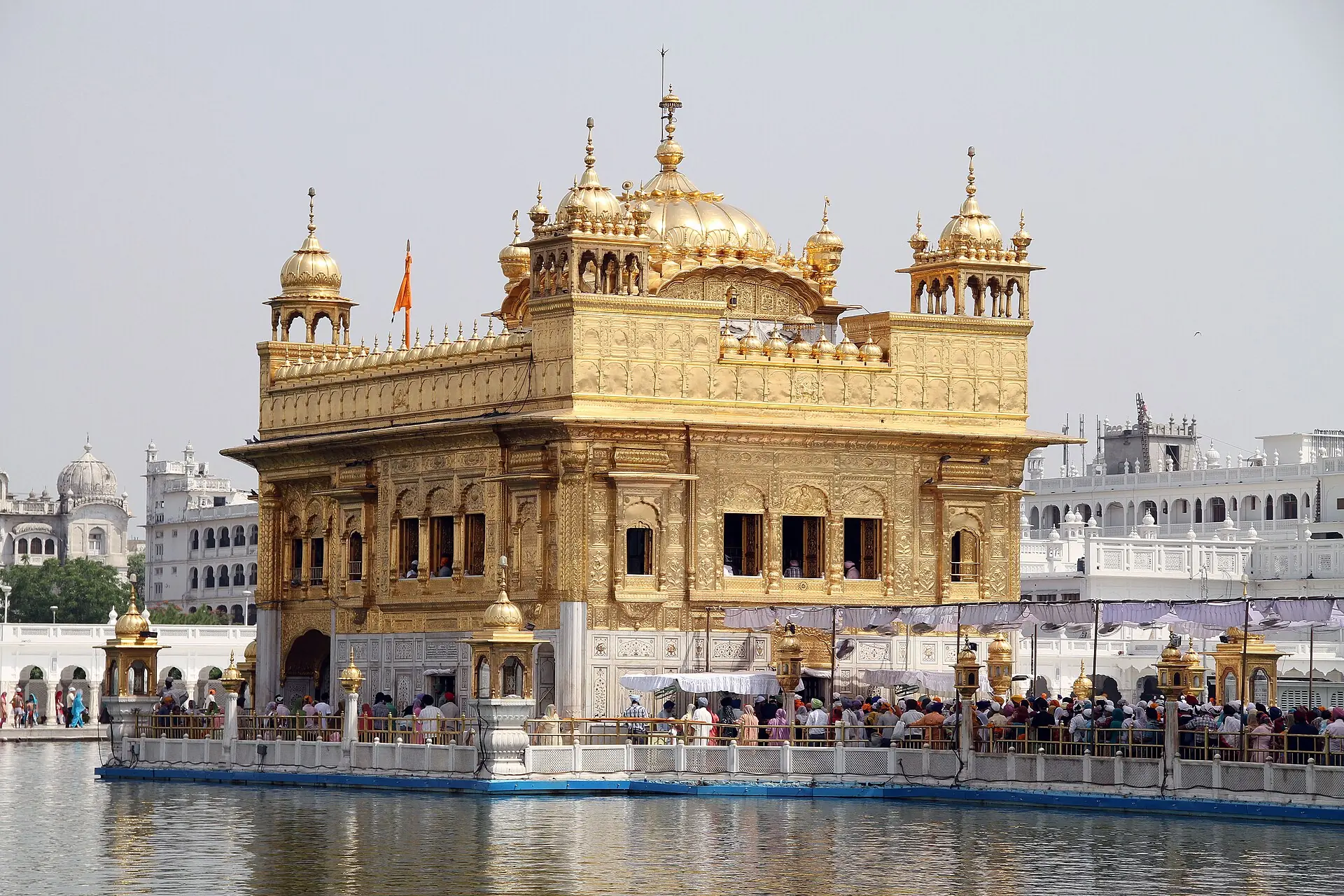 The Golden Temple and its reflection in the holy tank under a pale sky