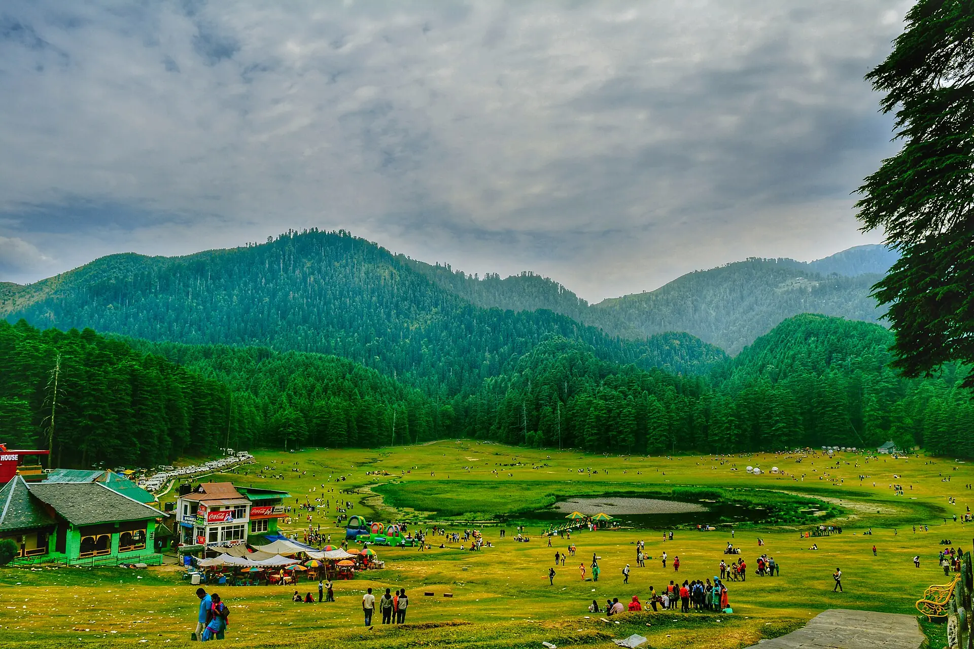 Khajjiar's green meadow and small lake surrounded by pine forest