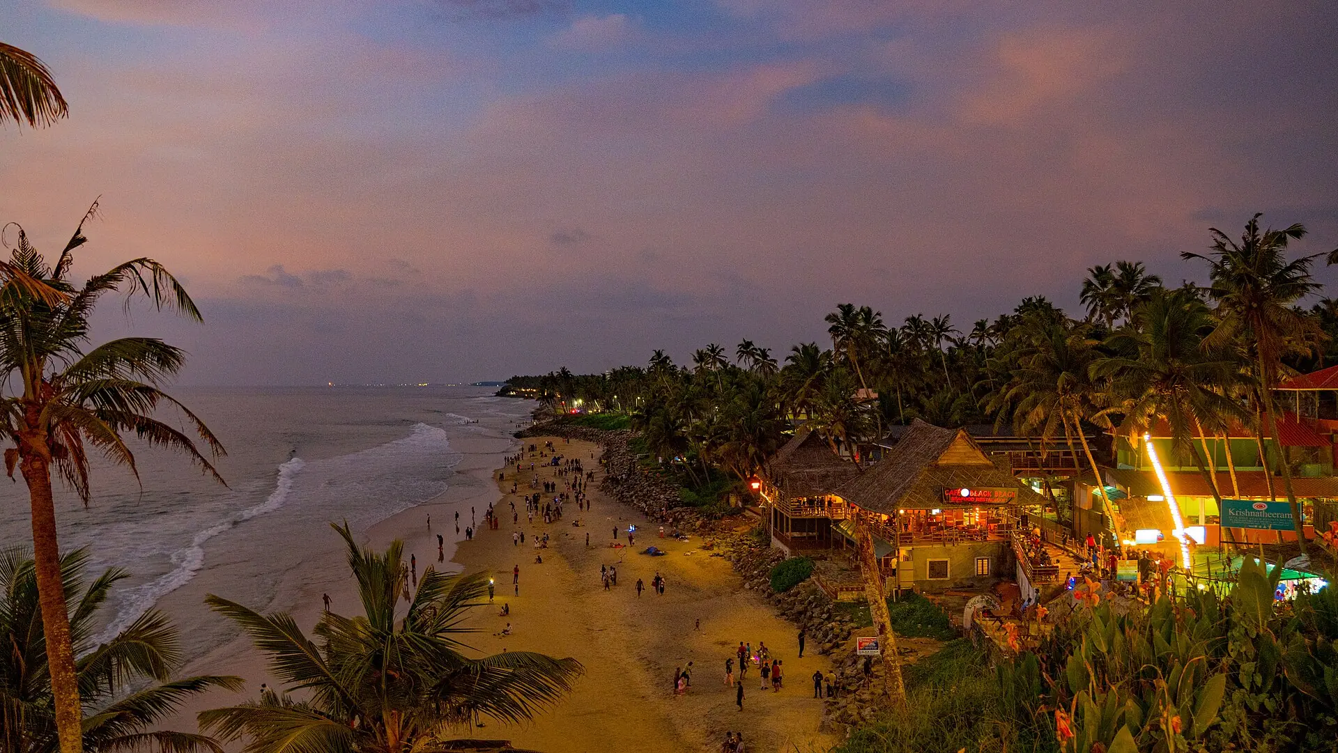 Lights along the Varkala cliff above the beach at dusk